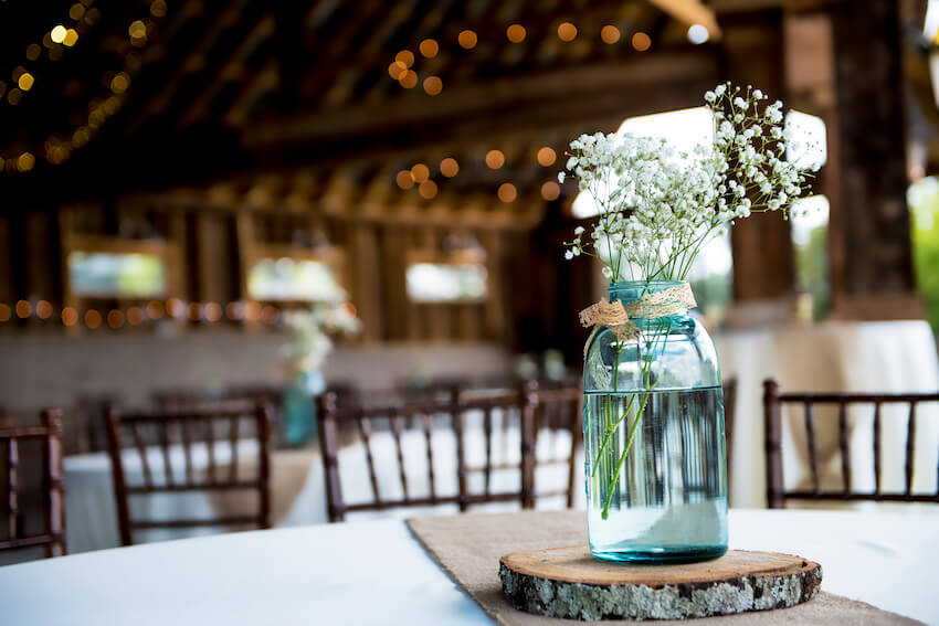 Budget rustic wedding ideas: jar of flowers on a table