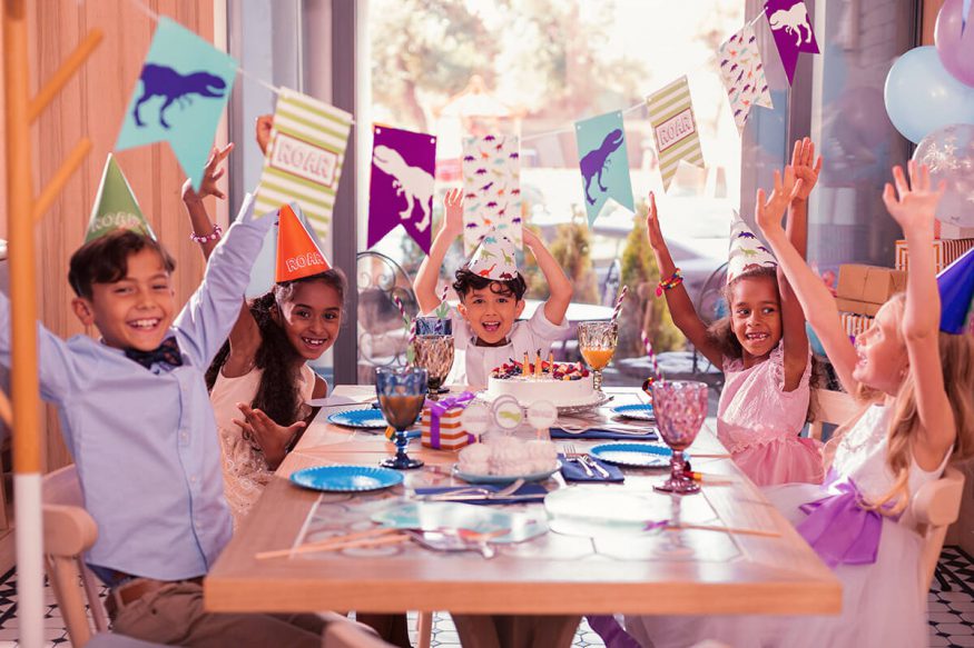 Dinosaur birthday invitations: kids at a children's party