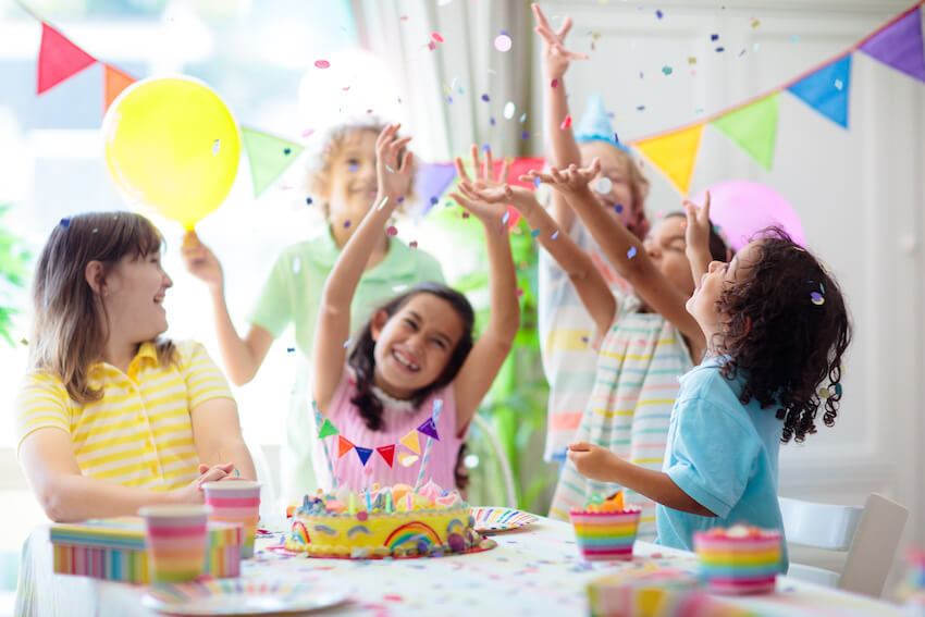 Birthday party checklist: kids throwing confetti up in the air