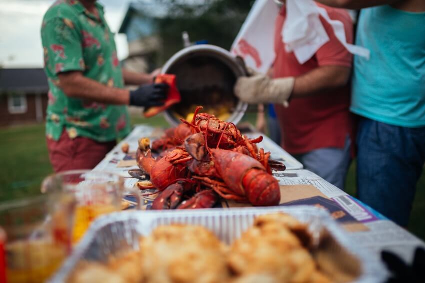 seafood boil party ideas: lobsters being served on a table