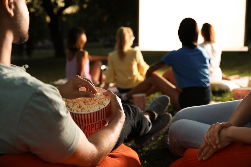 Birthday ideas for teenage girl: man eating popcorn while watching a movie
