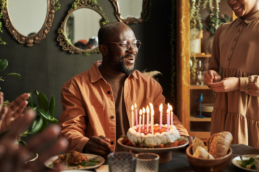 Happy birthday wishes for him: man happily celebrating his birthday with his family
