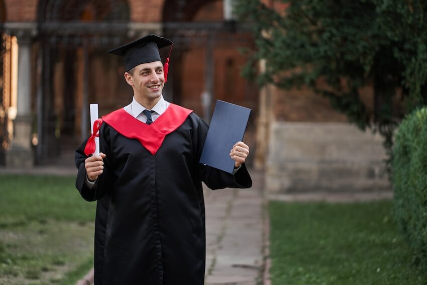 Graduation gifts for him: man holding his diploma