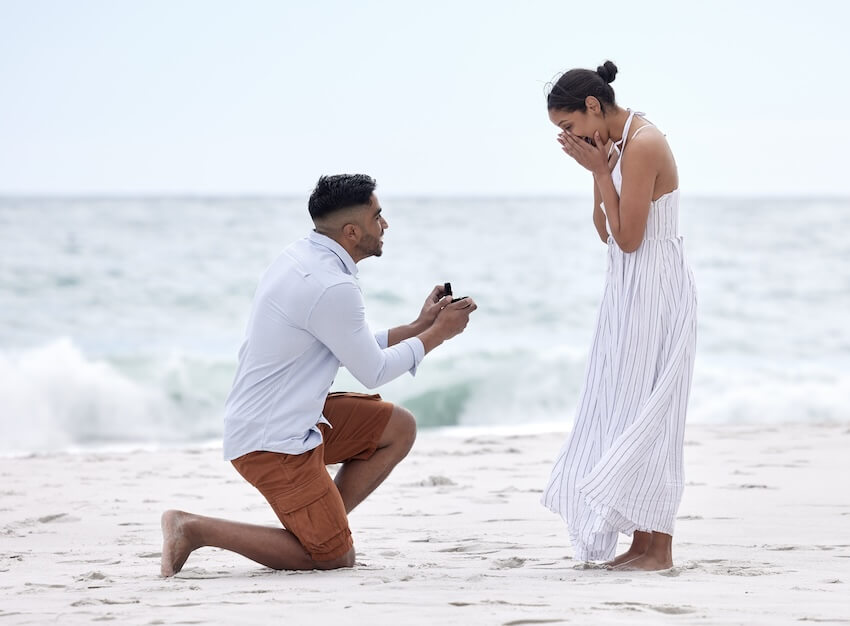 Beach proposal: man proposing to his partner