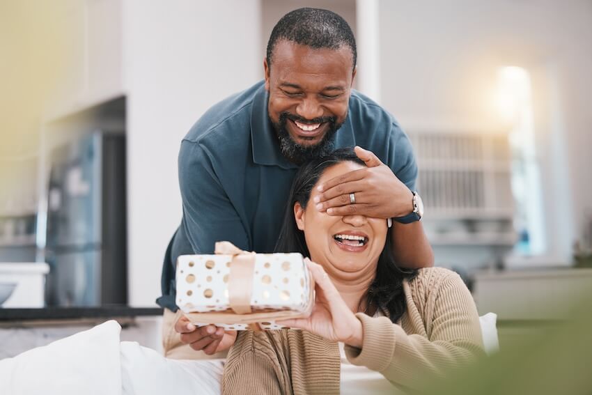 30th wedding anniversary gift: man surprising his wife with a gift