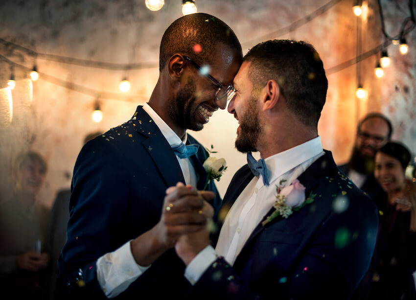 Gay wedding: married couple happily dancing