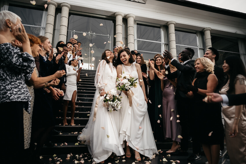 Cocktail dress code: married couple happily walking down the stairs