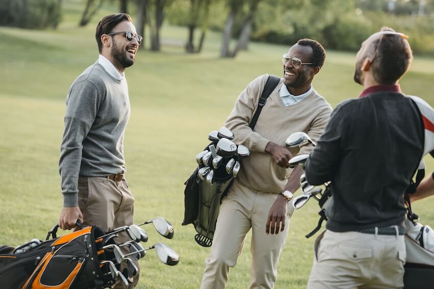 Groomsmen gift ideas: men carrying golf bags