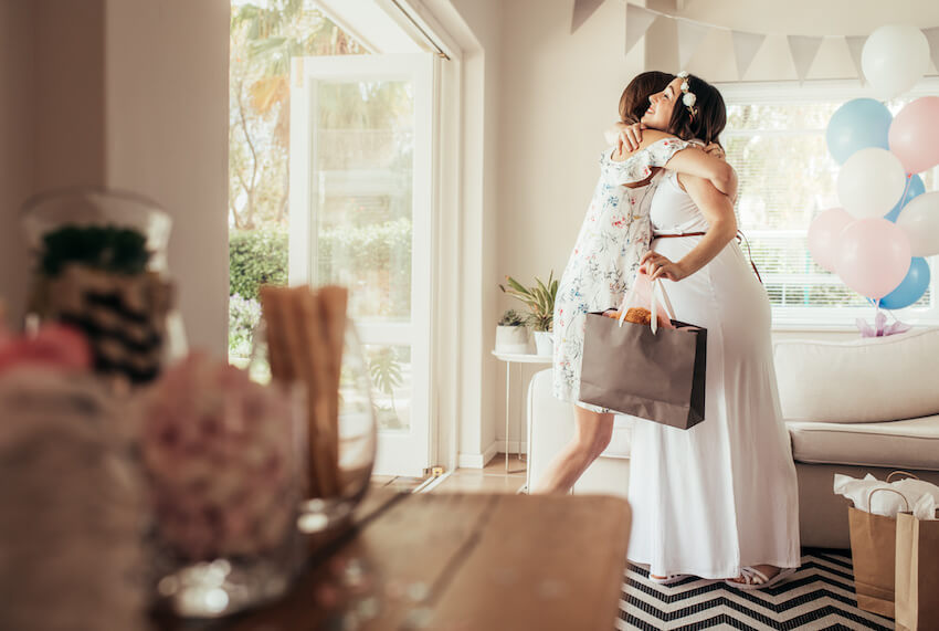 Baby sprinkle ideas: mother hugging her friend