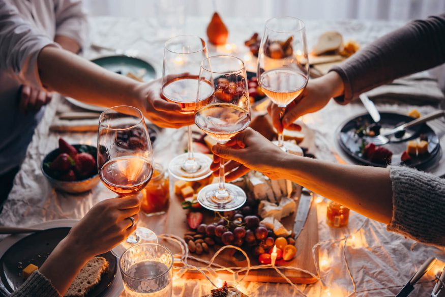 Fall birthday party ideas: people clinking wine glasses