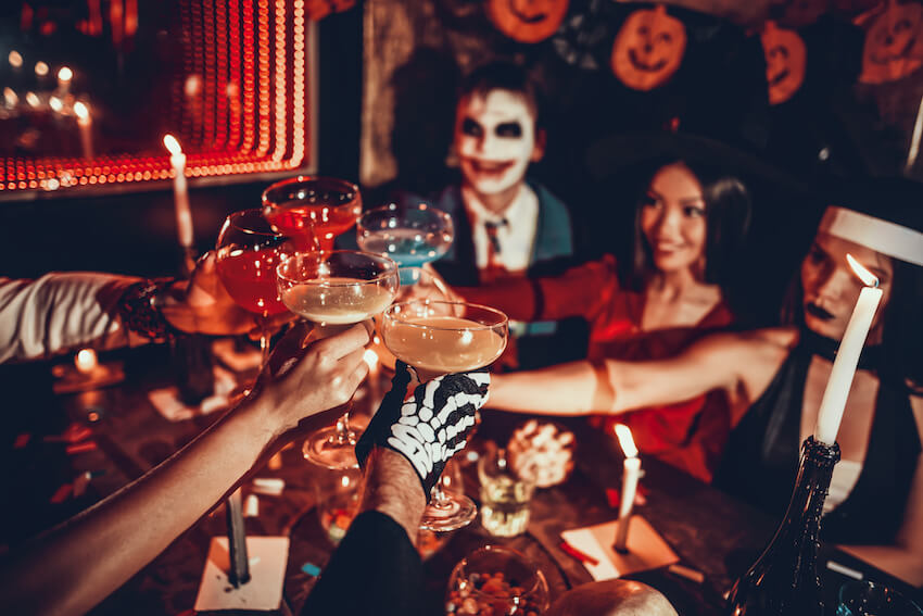 People having a toast at a Halloween costume party