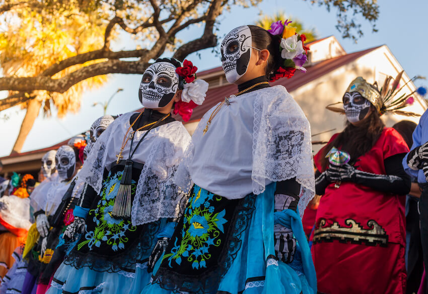 People wearing traditional costumes for Dia de los Muertos celebration