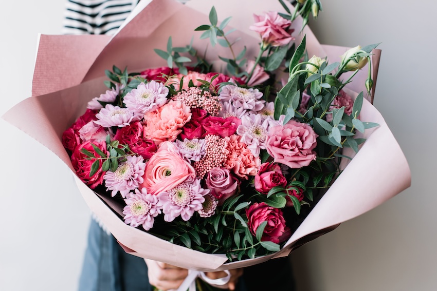 Person holding a bouquet of flowers