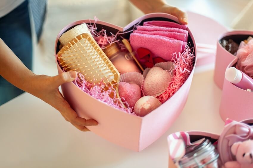 Bridal shower favor ideas: person holding a heart-shaped gift box