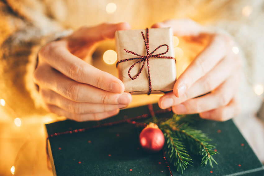 Gift exchange ideas: person holding a small gift