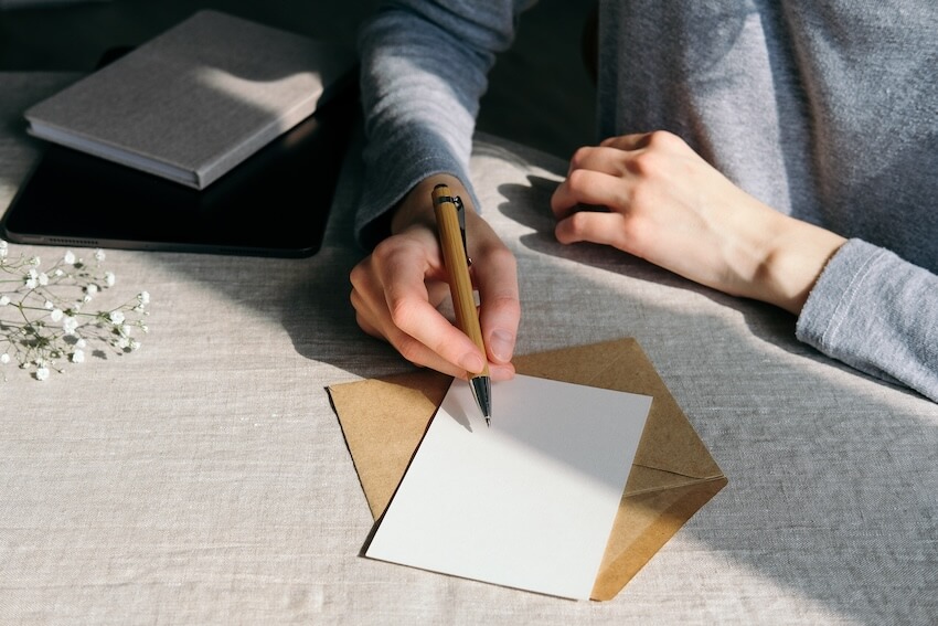 Person writing on a card