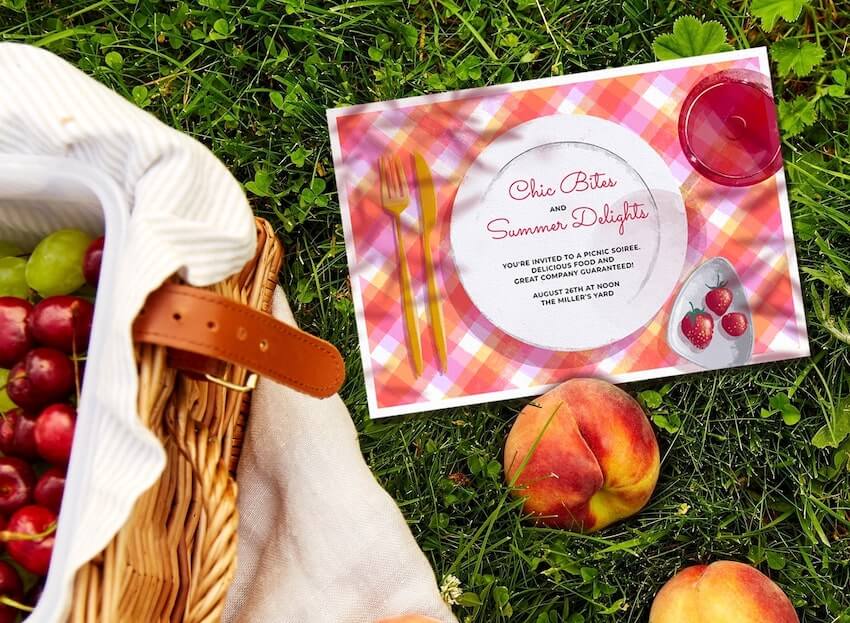 Picnic invitation card and 2 apples on the grass