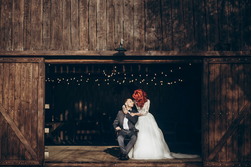 Farm wedding: portrait of a bride and a groom at a farm house