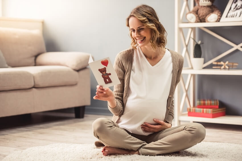 Pregnant woman reading a letter