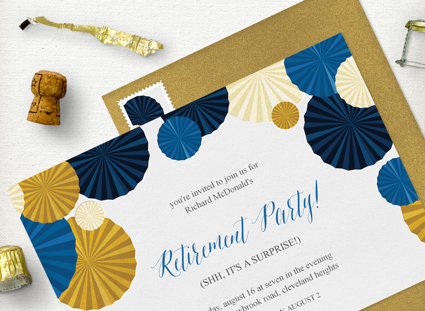 A retirement party invitation laid out with an envelope, champagne cork, and champagne foil