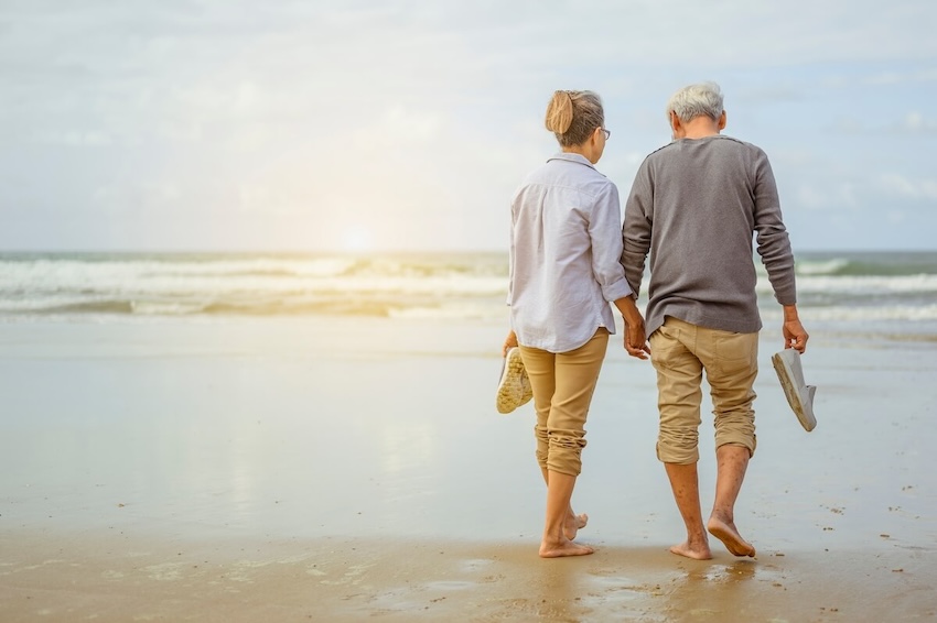 Senior couple walking at a beach