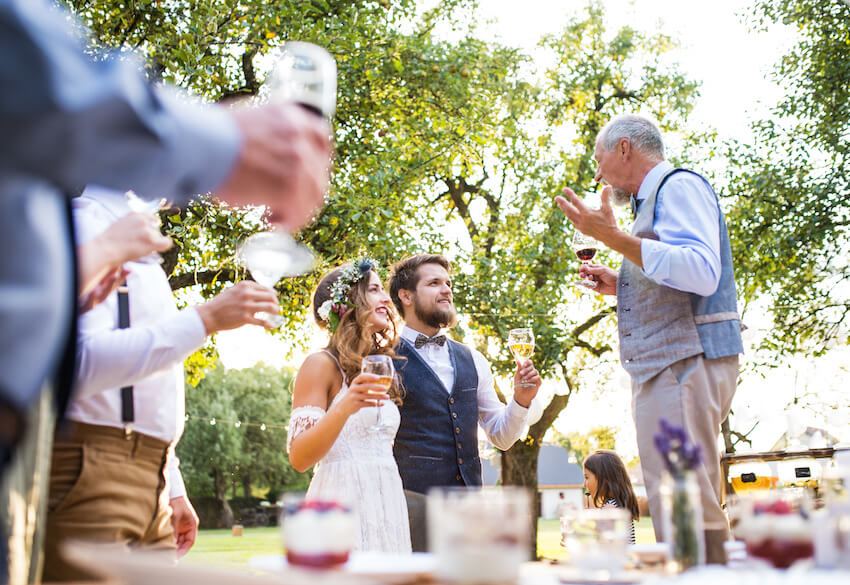 Post elopement party: senior man giving a speech to the newlyweds