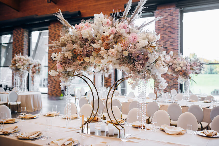 Fairytale wedding theme: table setting with a large floral centerpiece
