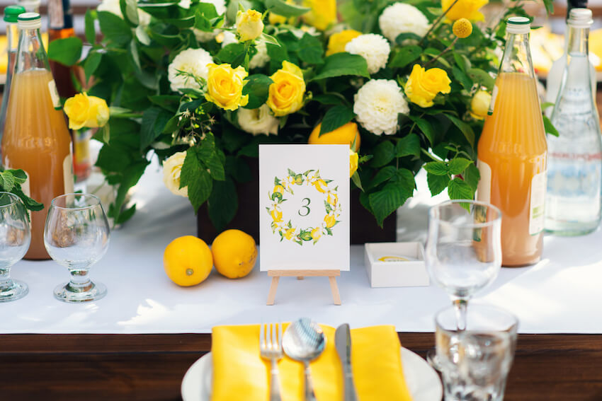 Lemon themed bridal shower: table setting with lemons and flowers