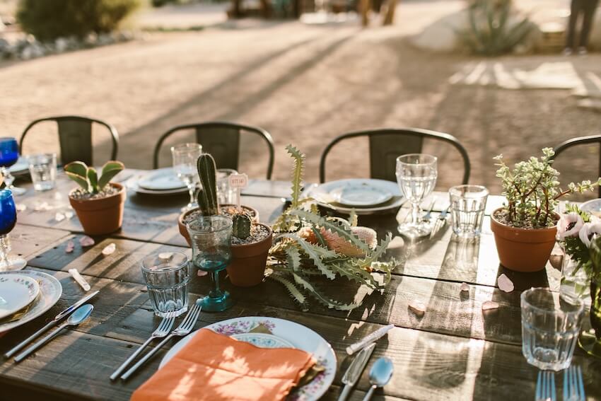 Green wedding: table setting with small potted plants