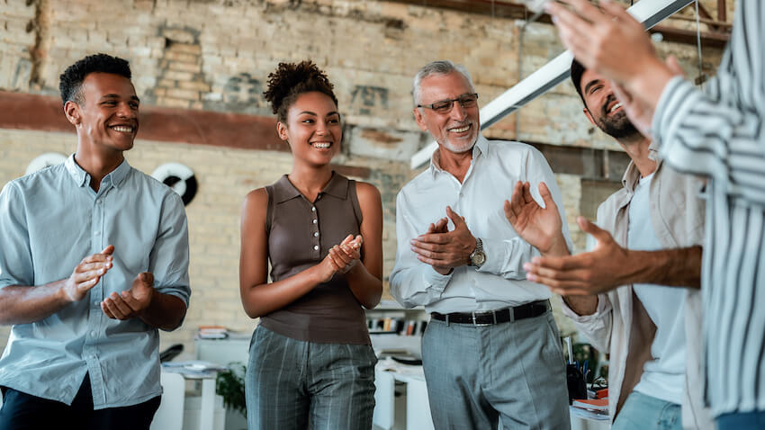 Workiversary: team happily clapping their hands