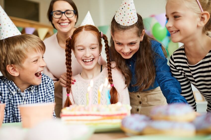 Joint birthday party invitations: teenagers looking at a birthday cake
