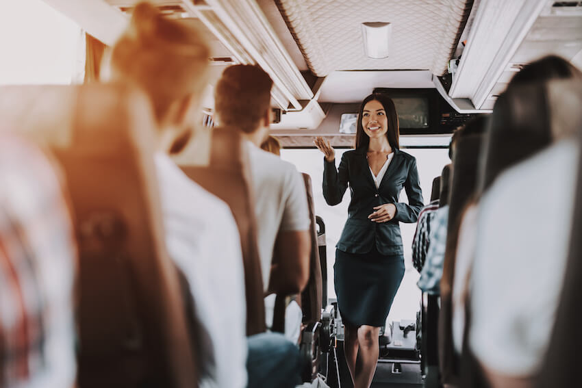 Employee Appreciation Day: tour guide talking inside a bus