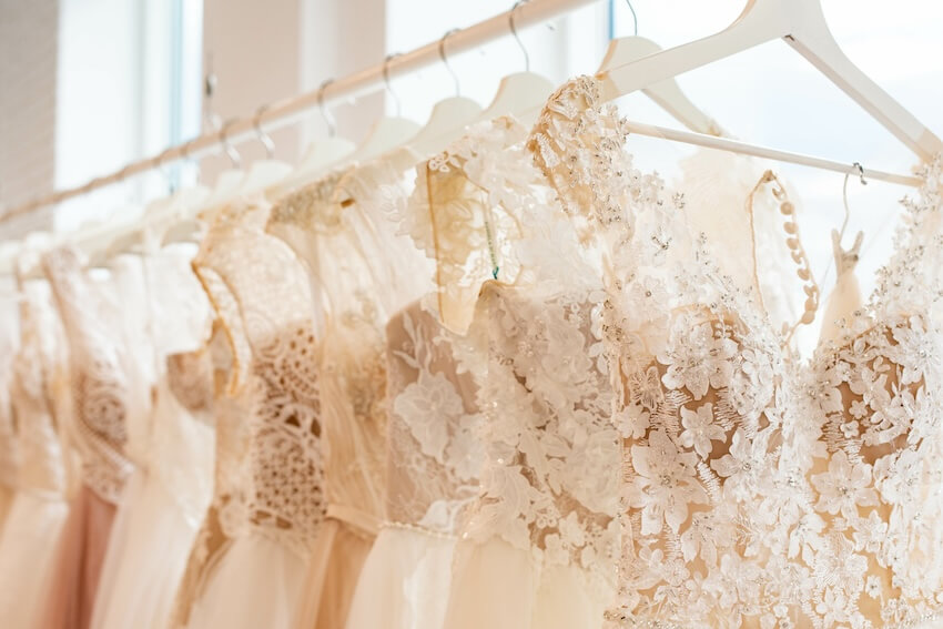 Traditional white wedding dresses hanging on a rack