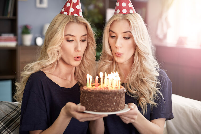 Twins birthday wishes: twins blowing their birthday cake candles