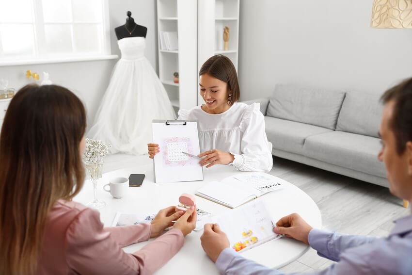 Wedding day timeline: wedding planner talking to a couple