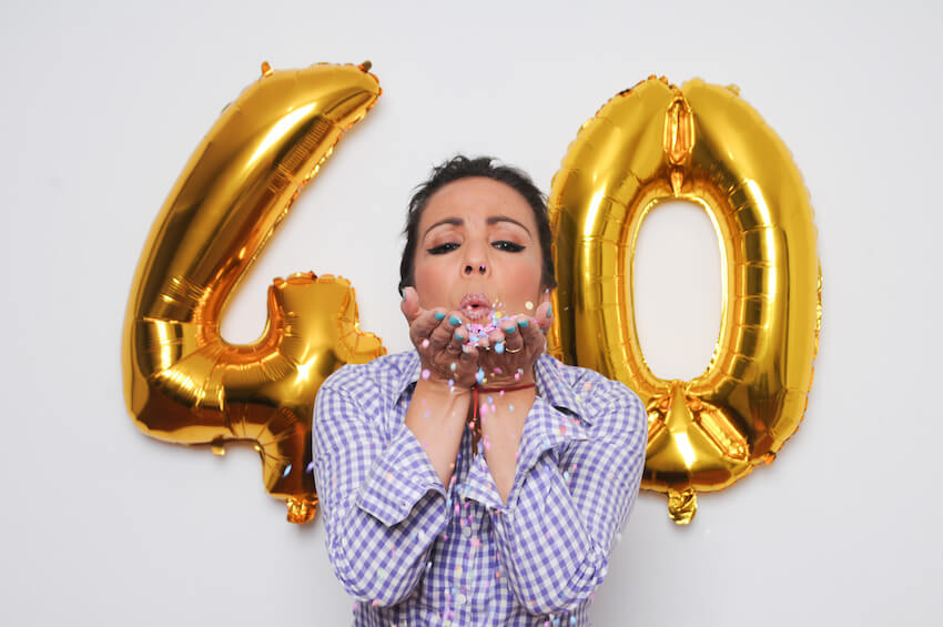 40th birthday ideas: woman blowing confetti from her hands