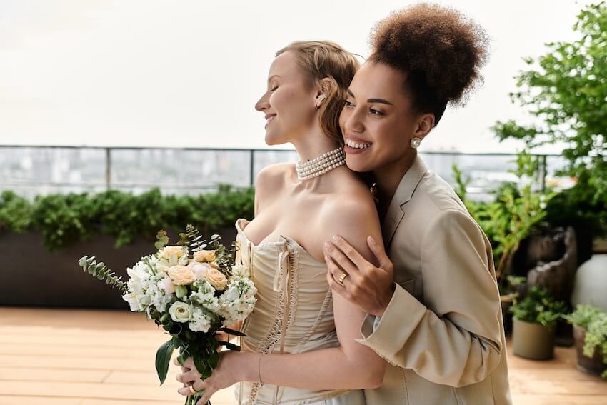 Types of weddings: woman happily back hugging her partner