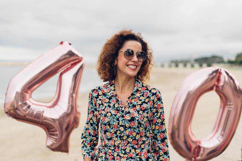 40th birthday ideas: woman happily celebrating her 40th birthday