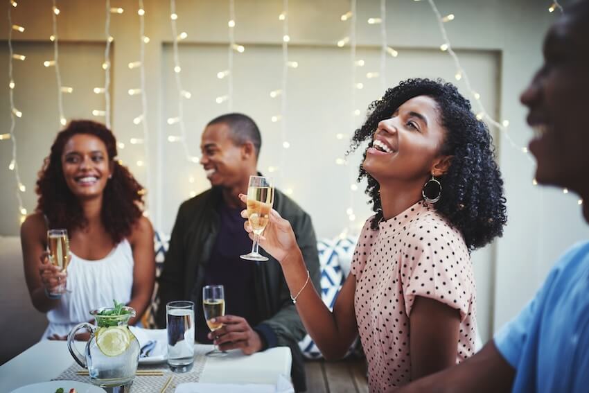 Couples wedding shower invitations: woman happily holding a glass of champagne