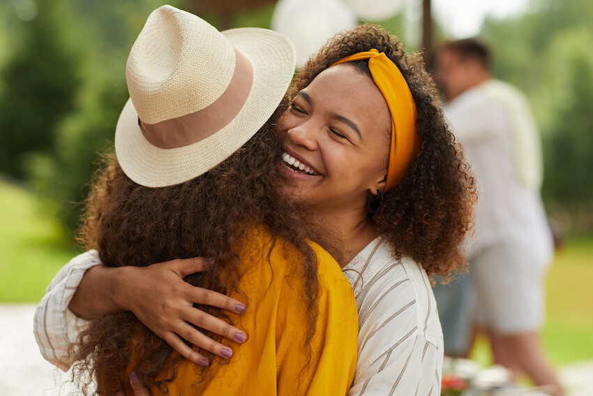 Custom thank you cards: woman happily hugging her friend