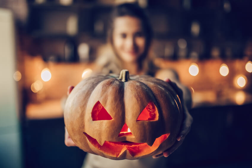 Woman holding a Halloween pumpkin