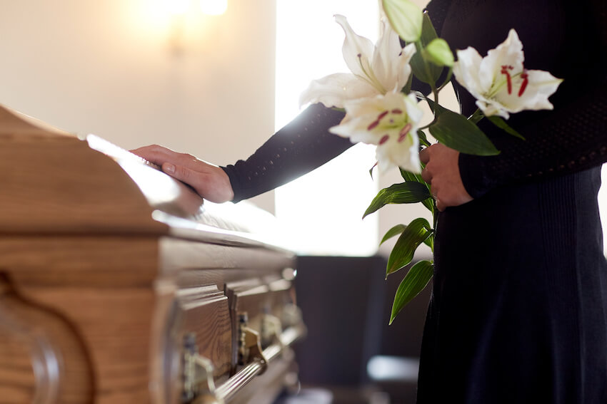 Funeral invitation: woman holding flowers at a funeral