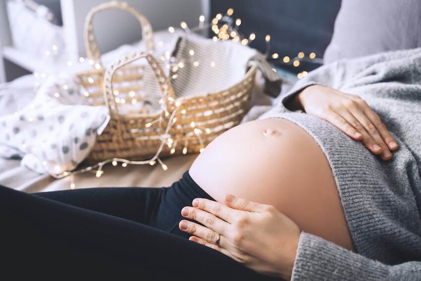 Pregnant woman holding her belly