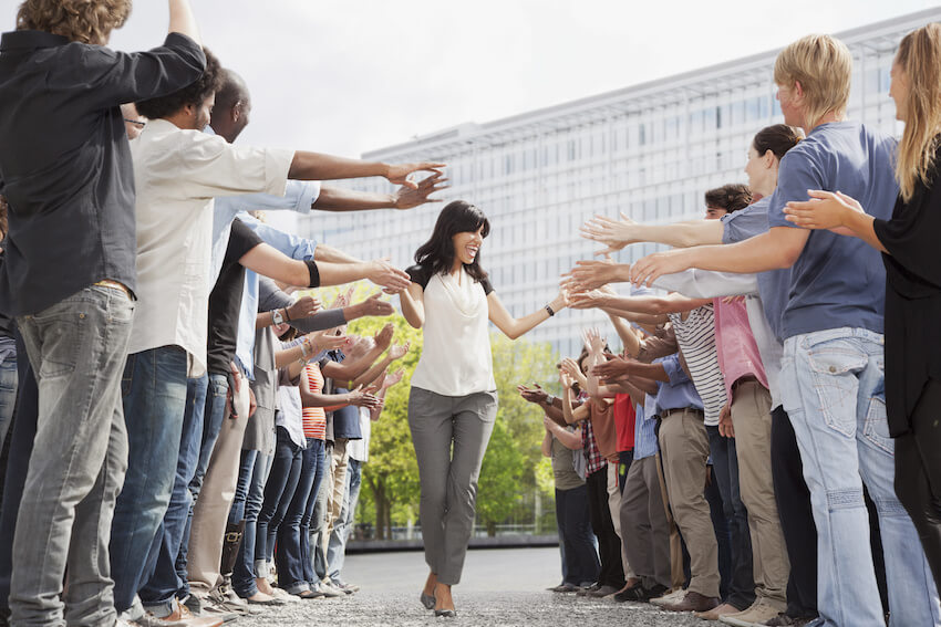 Woman shaking hands with her colleagues