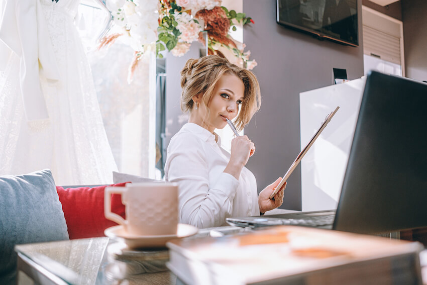 Woman thinking while looking at her computer