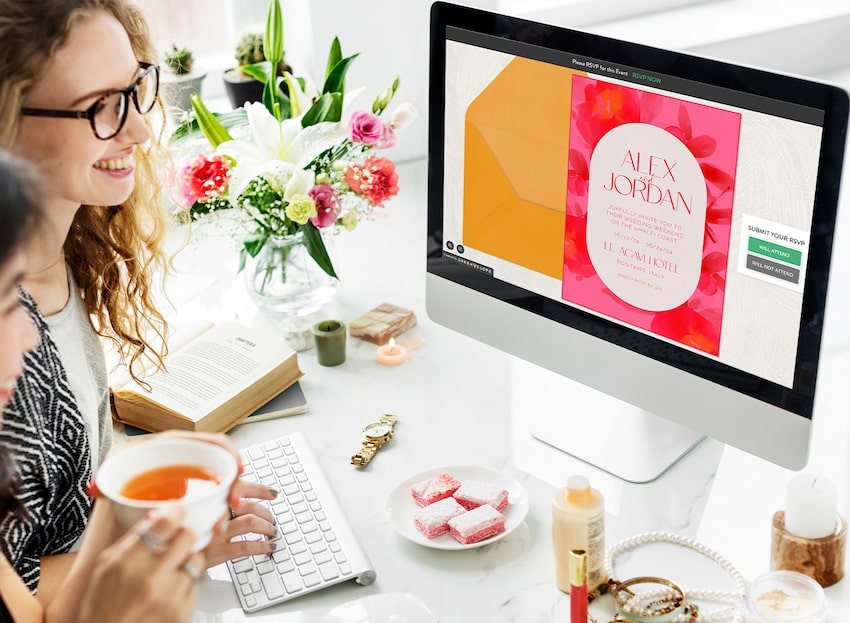 Custom party invitations: woman using a computer to view an invitation