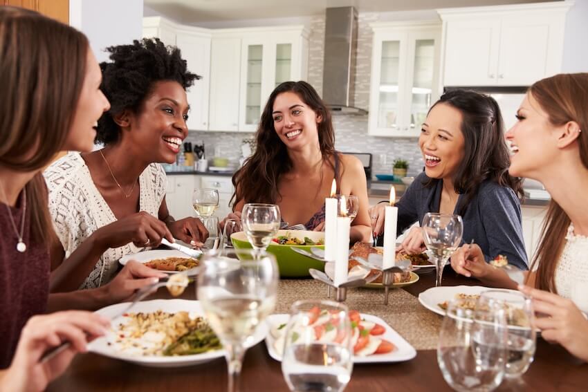 Women happily eating while talking to each other