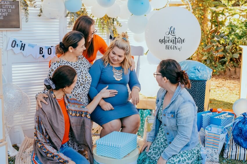 Baby shower ideas for boys: women talking to each other at a baby shower