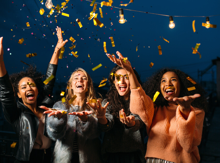 Golden birthday: women throwing confetti in the air