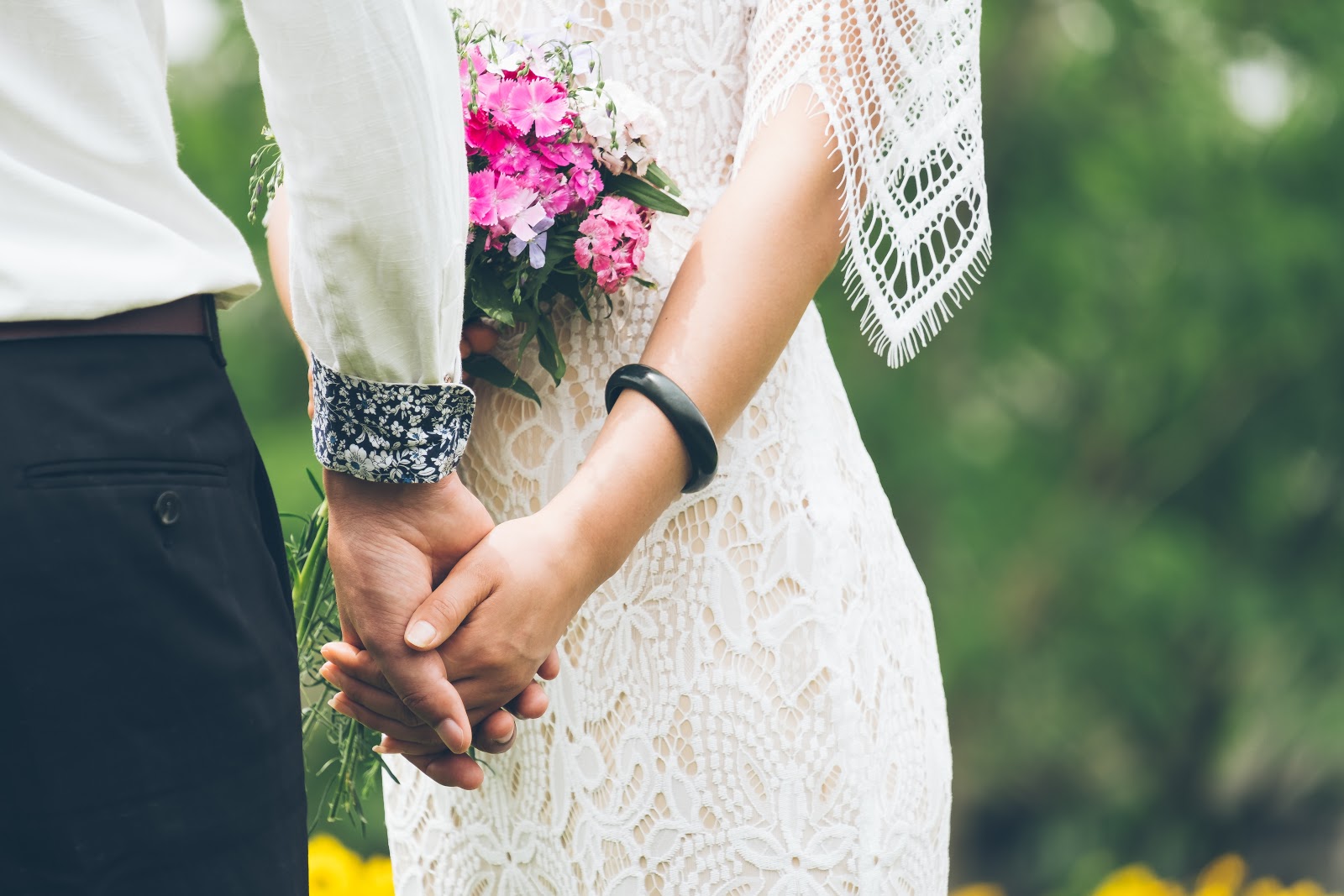 When to send save the dates: bride and groom hold hands